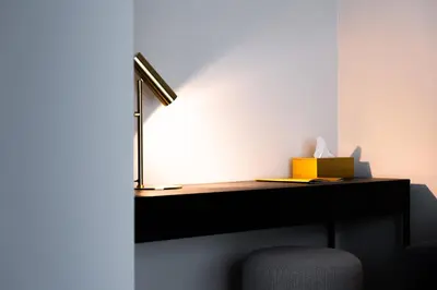 a desk with a lamp and a box on it at Porta Cité in Maasmechelen