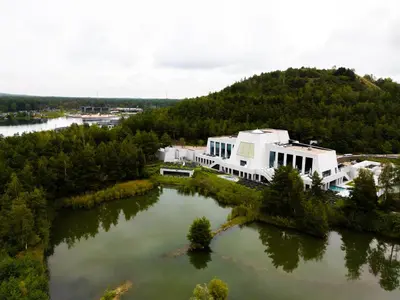 an aerial view of a building on a lake at Porta Cité in Maasmechelen