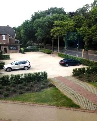 two cars are parked in a parking lot at Porta Cité in Maasmechelen