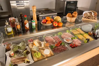 a buffet with a lot of different types of food at Sleepwood Hotel in Eupen
