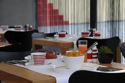 a table with bowls and plates of food on it at Hotel Corbie Lommel in Lommel