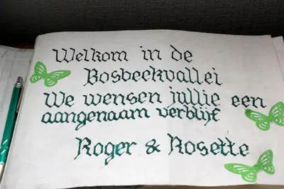 a handwritten sign with butterflies on a piece of paper at Bosbeekvallei in Opoeteren