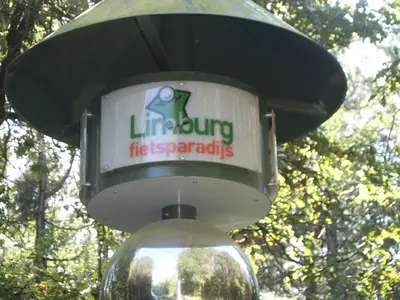 a light with a sign on top of it at Bosbeekvallei in Opoeteren