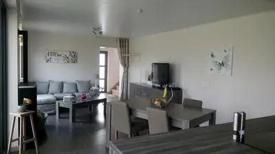 a living room with a couch and a table at La renaissance in Villers-lʼÉvêque