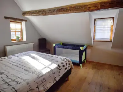 a bedroom with a bed and two windows at Limbourg Nature Retreat in Hèvremont