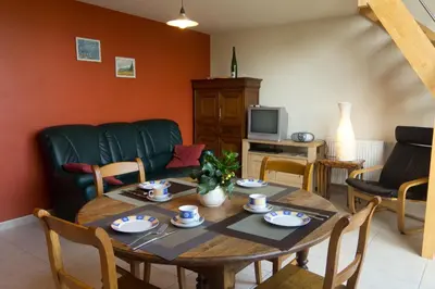 a living room with a table and a couch at 't Gillebroek in Borgloon