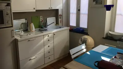 a small kitchen with a sink and a table at Tongeren Schuttersgang 1 in Tongeren