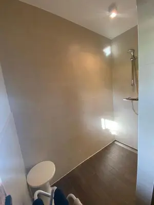 a small bathroom with a toilet and a stool at En Vert & En Pause in Thimister