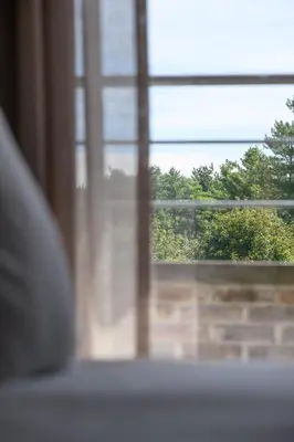 a window with a view of a brick wall at Stiemerheide - The Urban Hotel & Golf Retreat 4 Star Superior in Genk