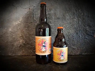 two bottles of beer sitting next to each other at Hotel Restaurant The Kings Head Inn in Voeren