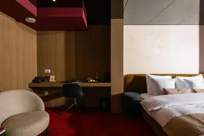 a hotel room with a bed and a desk at La Butte aux Bois a Small Luxury Hotel of the World in Lanaken