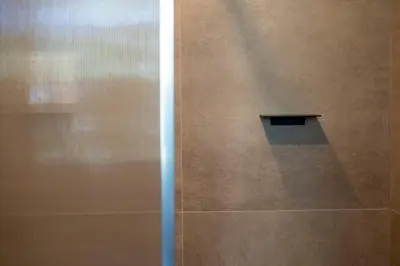 a glass door with a window in a room at Green Hotel in Genk