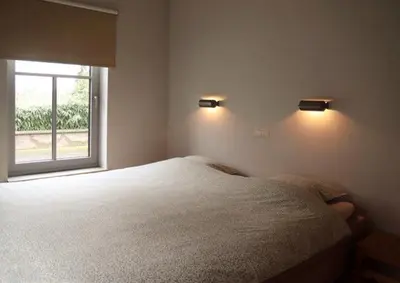 a bedroom with a large bed and a window at d'Uyterwaerde in Leut