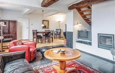 a living room with a couch and a table at Seven-Bedroom Holiday Home In Remersdaal in Remersdaal