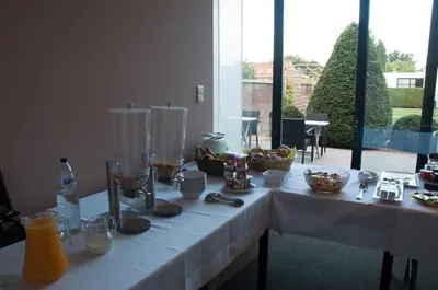 a white table with food and drinks on it at Hotel Boomgaard in Lanaken