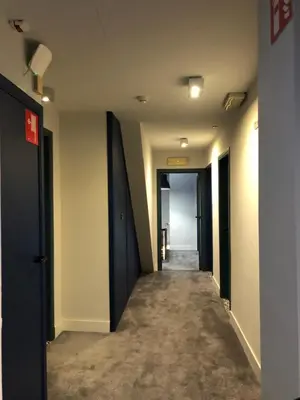 an empty hallway with doors and a hallway with a corridorngthngthngthngthngth at Hotel Le Cygne d'Argent in Liège
