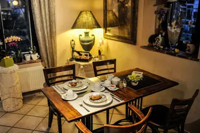 a dining room table with a plate of food on it at B&B De Dubbelmolen in Tongeren