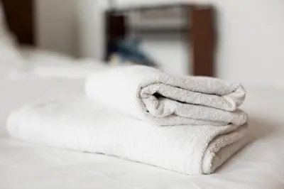 a pile of towels sitting on top of a bed at Maison Sainte-Marguerite in Liège