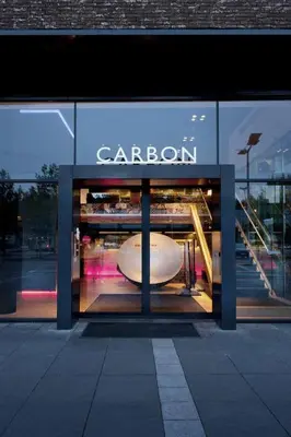 a store window with a caron sign on it at Carbon Hotel in Genk