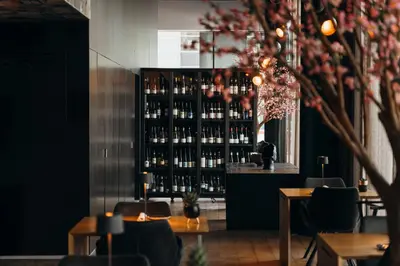 a restaurant with a shelf of bottles of wine at Carbon Hotel in Genk