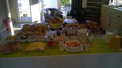 a table topped with lots of different types of food at B&B De Edelsteen in Zutendaal