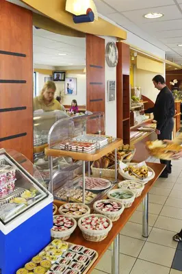 a bakery with many different types of pastries on display at ibis budget Aachen Raeren Grenze in Raeren