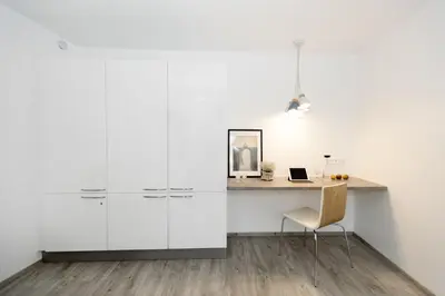 a white office with a desk and a chair at Xperience-Today Eupen in Eupen
