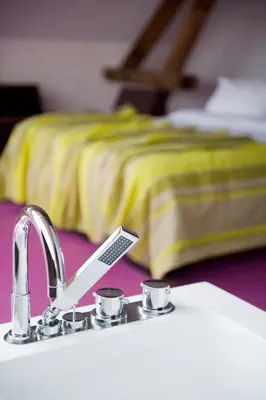 a bathroom sink with a toothbrush and a toothbrush holder at Eburon Hotel in Tongeren