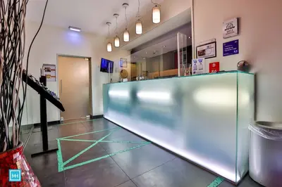 a large glass partition in a room with a counter at Hotel De La Couronne Liege in Liège