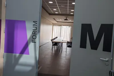 an open door to a meeting room with a table at Mezzo Hotel & Business in Beringen
