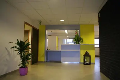a hallway with colorful walls and plants in a building at Gîte Kaleo Eupen Jugendherberge in Eupen