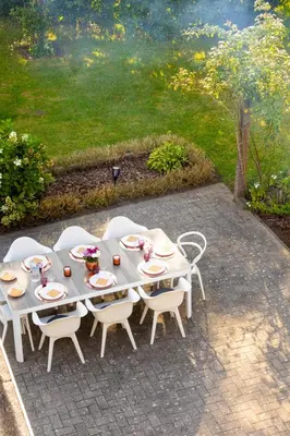 a table and chairs on a patio with a painting at De Koperen Geit in Kanne