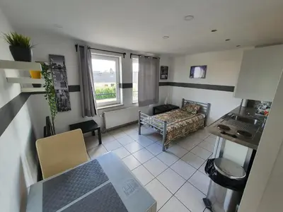 a living room with a couch and a table at Studio Filo in Liège