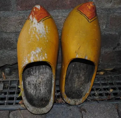 two orange shoes sitting on top of a grate at B&B Elegance Hamont in Hamont-Achel