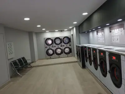 a laundry room with four washing machines in it at Appartement Au Coeur de Liege in Liège
