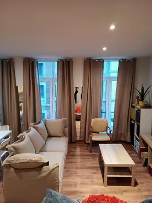 a living room with a couch and a table at Appartement Au Coeur de Liege in Liège