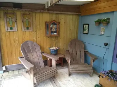 two chairs and a table on a patio at B&B Dream On Wheels in Lommel
