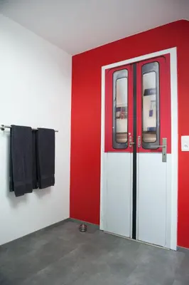 a red and white room with a red and white door at Villa Lumina in Membach