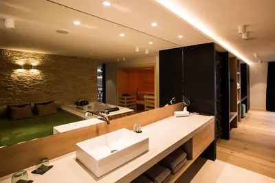 a bathroom with a sink and a large mirror at Wellness Hasselt B&B in Hasselt