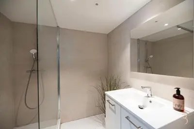 a bathroom with a shower and a sink and a mirror at Smart Bnb - Hotel Battice in Battice
