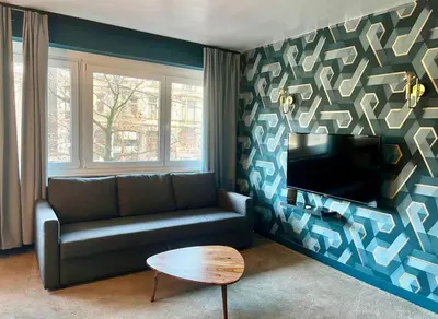a living room with a couch and a table at DayNight Sauveniere in Liège