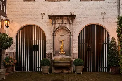 a building with a statue of a giraffe on the door at Faubourg Saint Martin in Liège