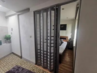 a room with a door to a bedroom with a bed at Ferienhaus Congolo in Lontzen