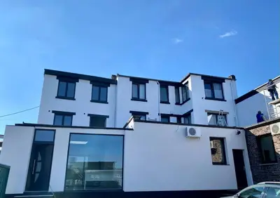 a white building with a large window in front of it at Fenêtre sur le Standard de Liège in Ougrée