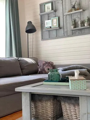 a living room with a couch and a coffee table at Chalet Sint-Hubertus in Zutendaal
