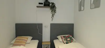 a living room with two beds and a couch at Den 1 Hengelhoef in Houthalen-Helchteren
