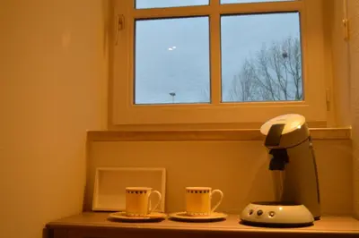 two coffee cups sitting on a counter in front of a window at Maison Margriet in Tongeren