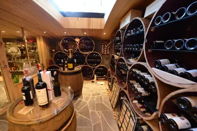 a wine tasting room with wine bottles on display at Les Coteaux du Vinave in Herve