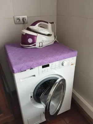 a fax machine sitting on top of a washing machine at Cosy Corner in Lommel