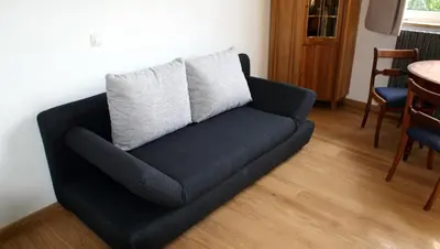 a blue couch with two pillows on top of it at Übernachten im ehemaligen Zollgebäude in Hauset